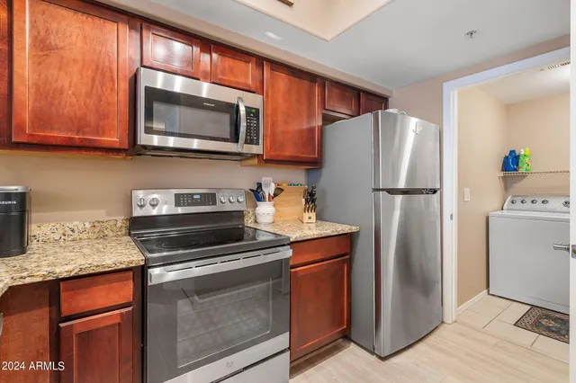 a kitchen with a refrigerator stove and microwave