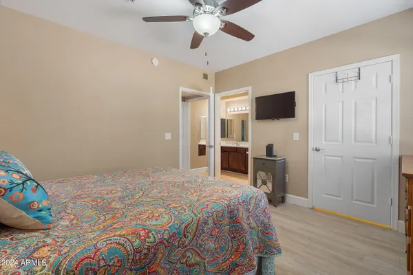 a bedroom with a bed and a flat screen tv