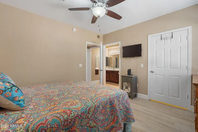 a bedroom with a bed and a flat screen tv