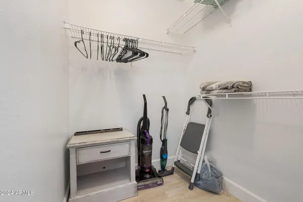 a view of walk in closet with clothes and shoes