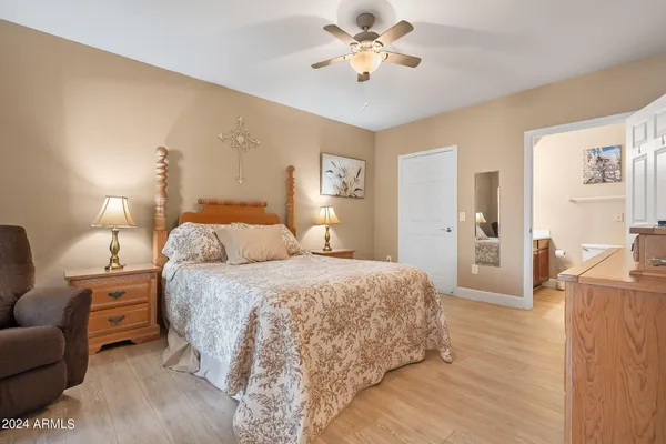 a spacious bedroom with a bed and a chandelier