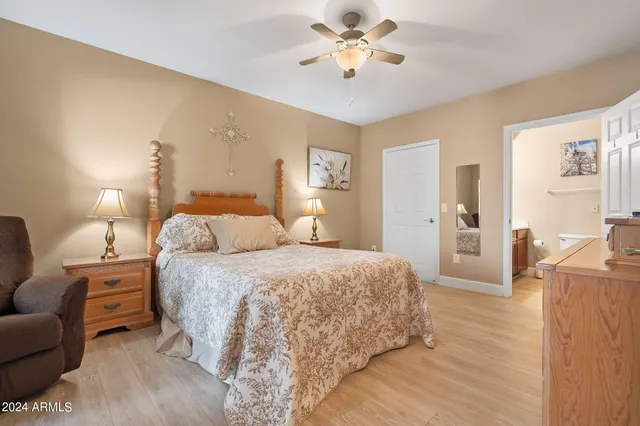 a spacious bedroom with a bed and a chandelier