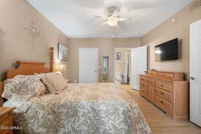 a bedroom with a bed and a flat screen tv