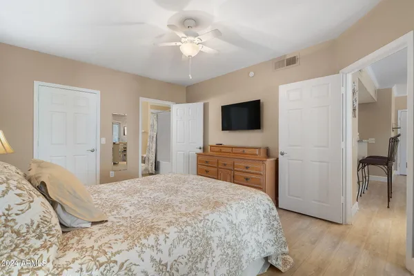 a bedroom with a bed and a flat screen tv