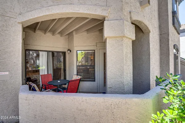 a view of hall way with furniture and floor to ceiling window