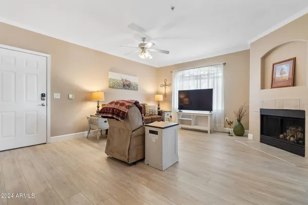 a living room with furniture a flat screen tv and a fireplace