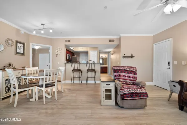 a living room with furniture a wooden floor and a chandelier