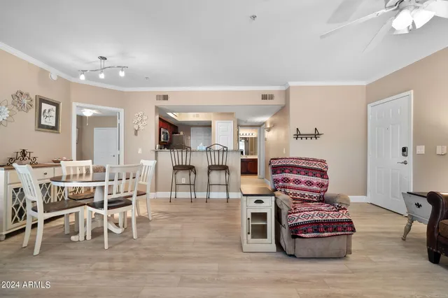 a living room with furniture a wooden floor and a chandelier