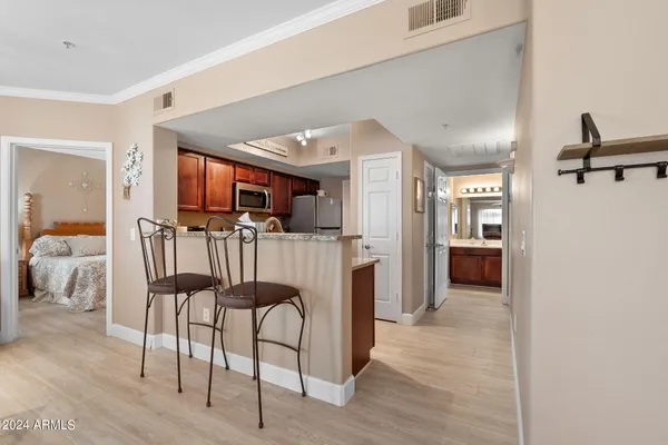 a room with furniture a mirror and a lamp