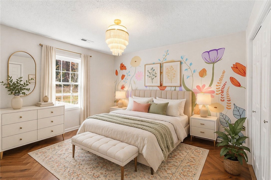 112 Newry Road Seneca, SC 29672 - Photo 9 of 19 This tranquil bedroom features a decorative chandelier and a charming floral wall design.