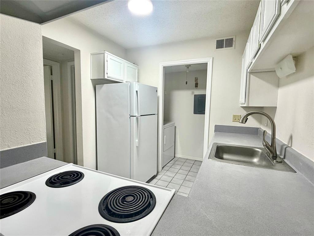 18333 Roehampton Drive, Unit 624 Dallas, TX 75252 - Photo 19 of 39 a bedroom with a bed and a sink
