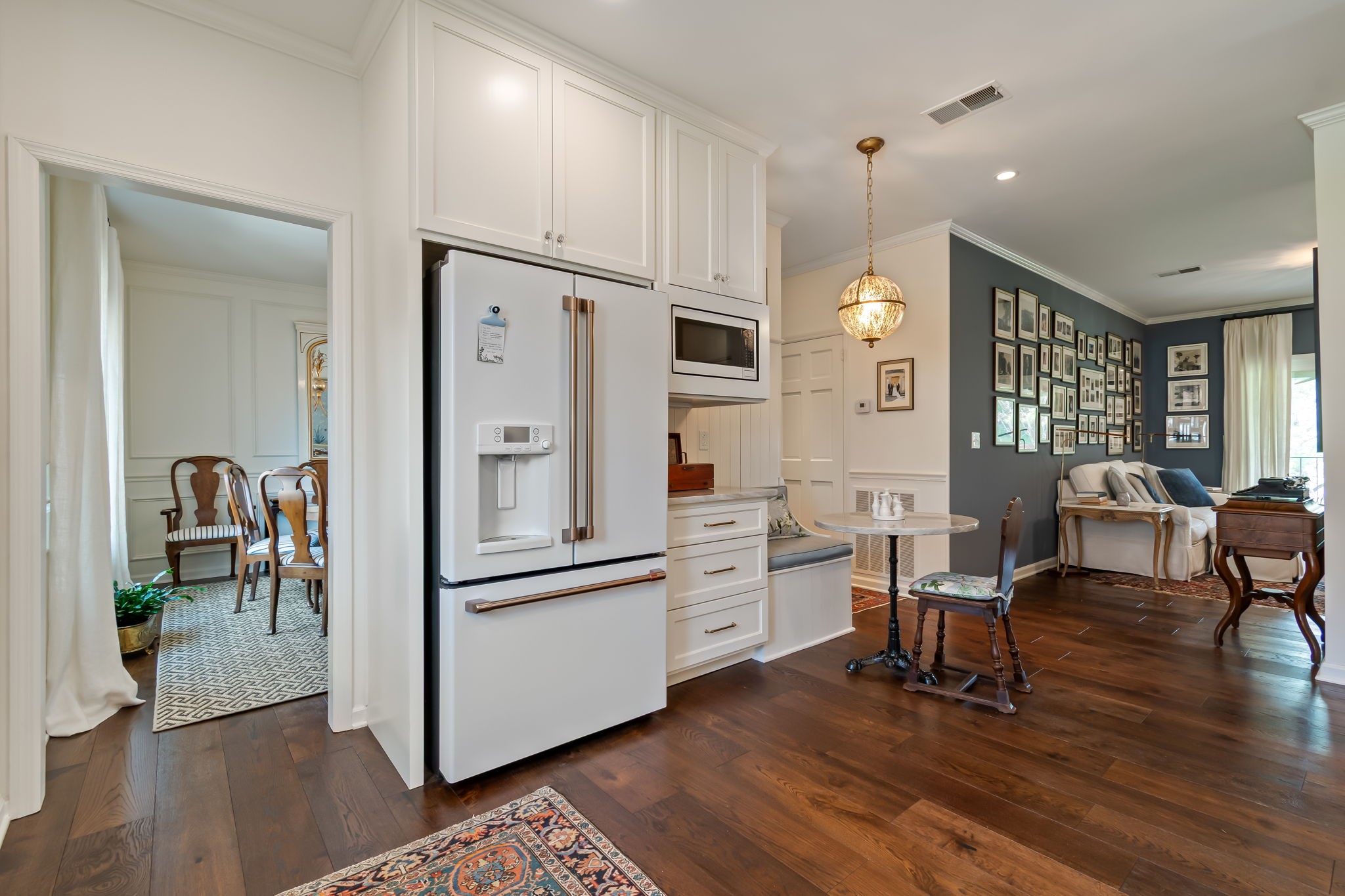 4487 Post Place, Unit 12 Nashville, TN 37205 - Photo 20 of 39 a kitchen with stainless steel appliances a refrigerator a stove a dining table and chairs with wooden floor