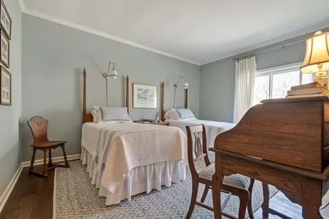 a bedroom with two beds and painting on the wall
