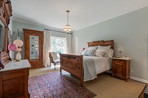 a bedroom with bed and window