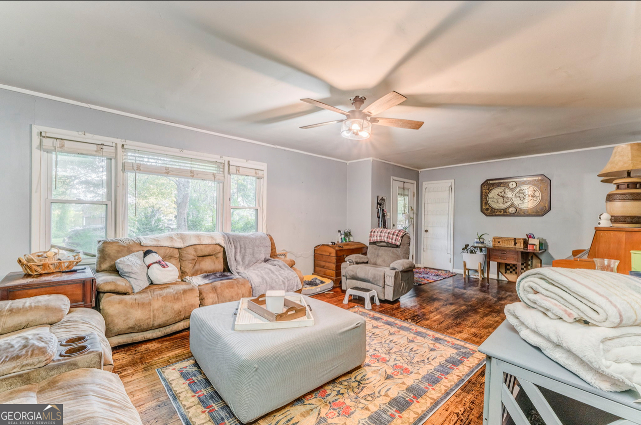 a living room with furniture large window and a table