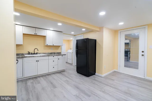 a kitchen with a refrigerator and a sink