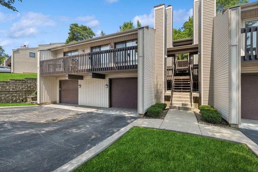 a view of a house with a yard and stairs