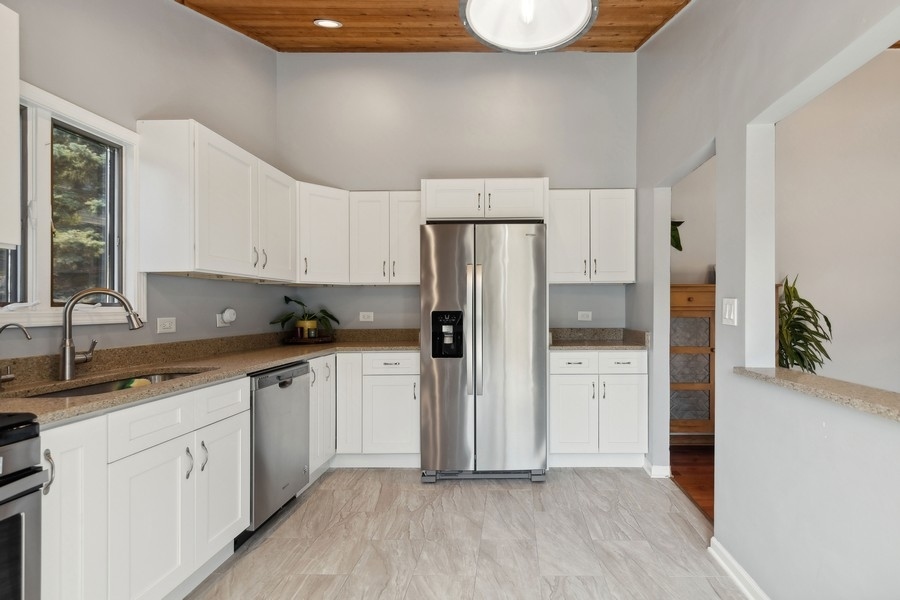 21 Mineola Road Fox Lake, IL 60020 - Photo 13 of 21 a kitchen with a refrigerator sink and cabinets