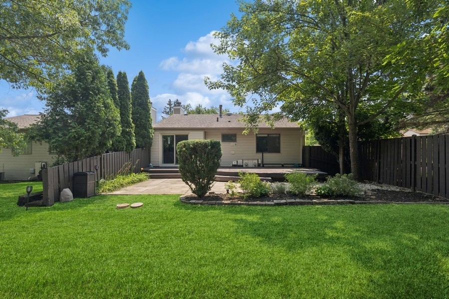 21 Mineola Road Fox Lake, IL 60020 - Photo 18 of 21 a view of a backyard with table and chairs and wooden fence