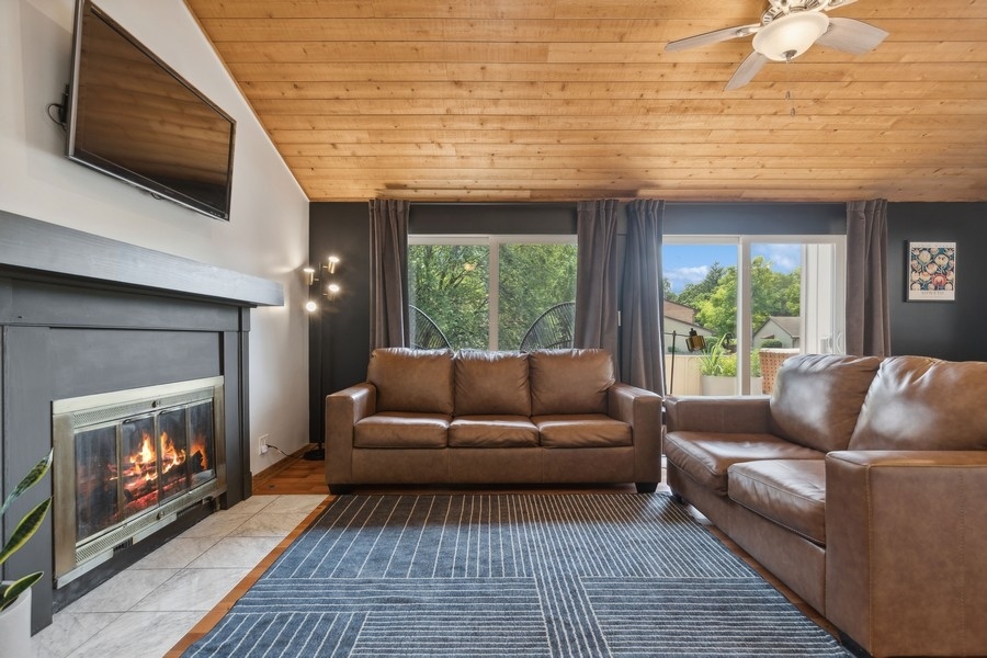 21 Mineola Road Fox Lake, IL 60020 - Photo 5 of 21 a living room with furniture a flat screen tv and a fireplace