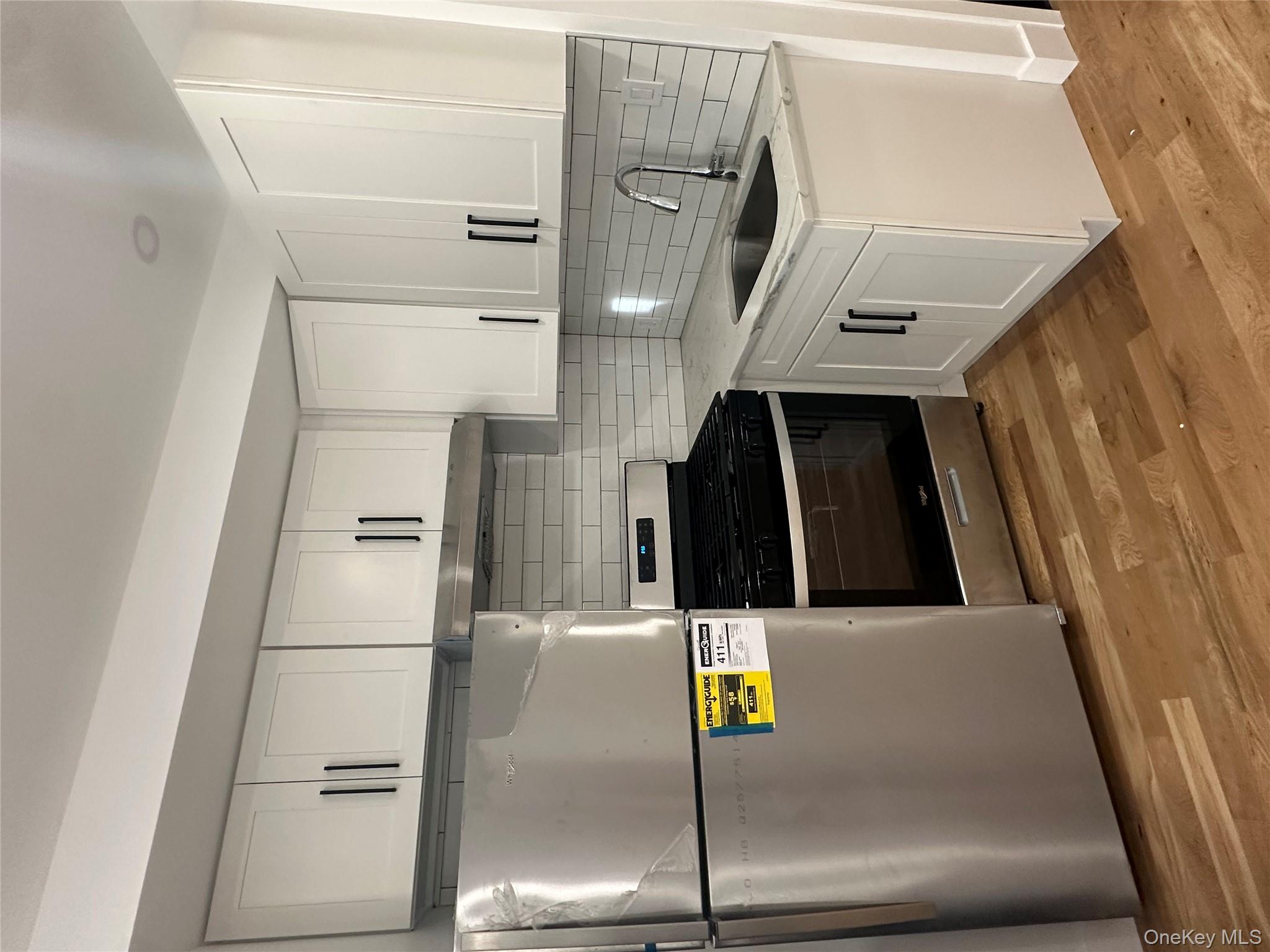Undisclosed Address Queens, NY 11416 - Photo 2 of 10 a kitchen with stainless steel appliances granite countertop a sink stove and refrigerator