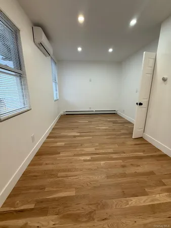 a view of a room with wooden floor