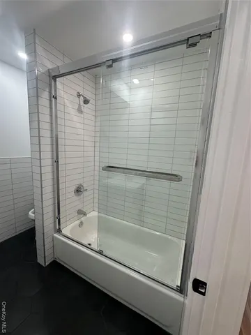 a bathroom with a shower and a bathtub