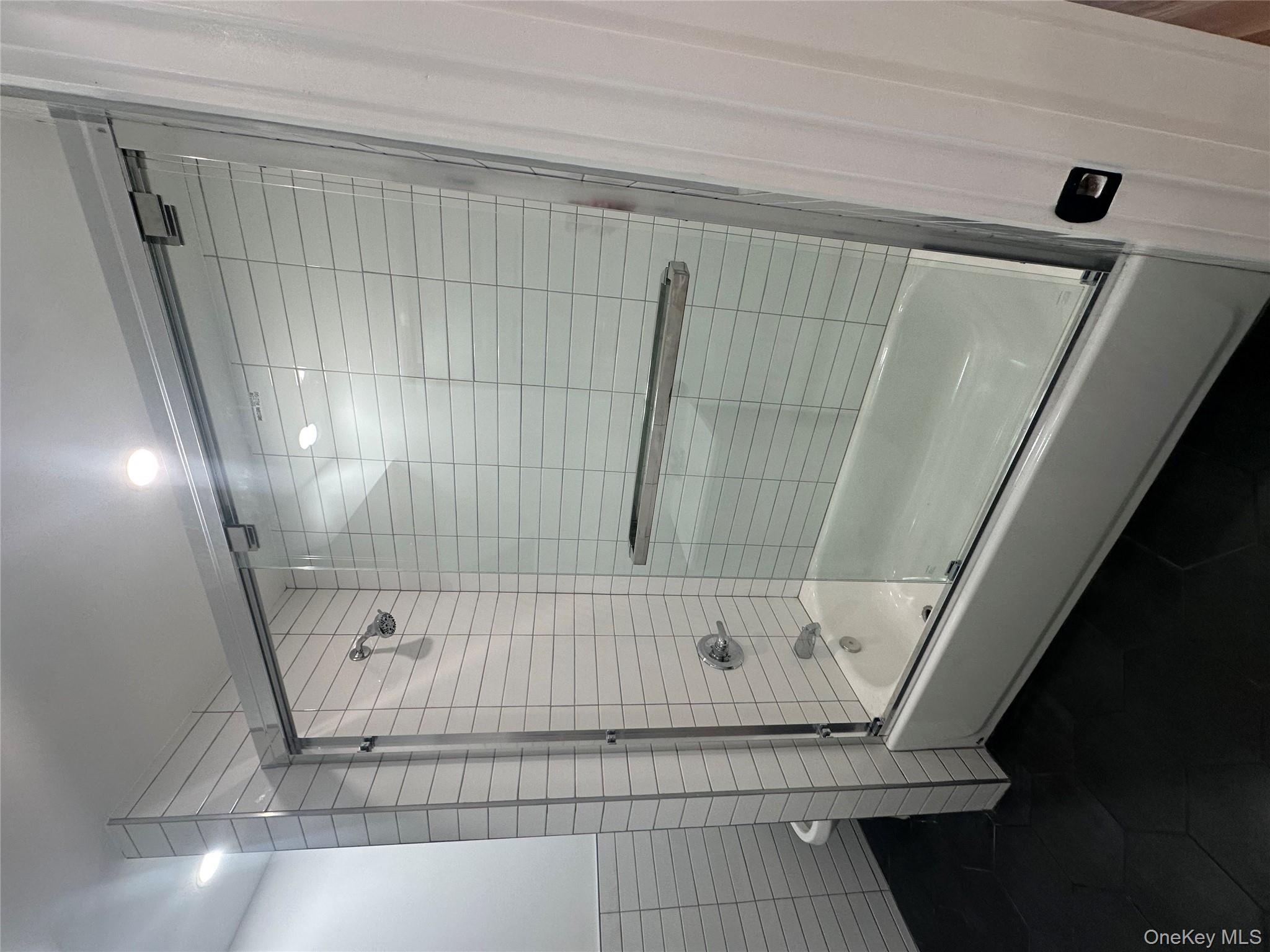 Undisclosed Address Queens, NY 11416 - Photo 8 of 10 a bathroom with a shower and a bathtub