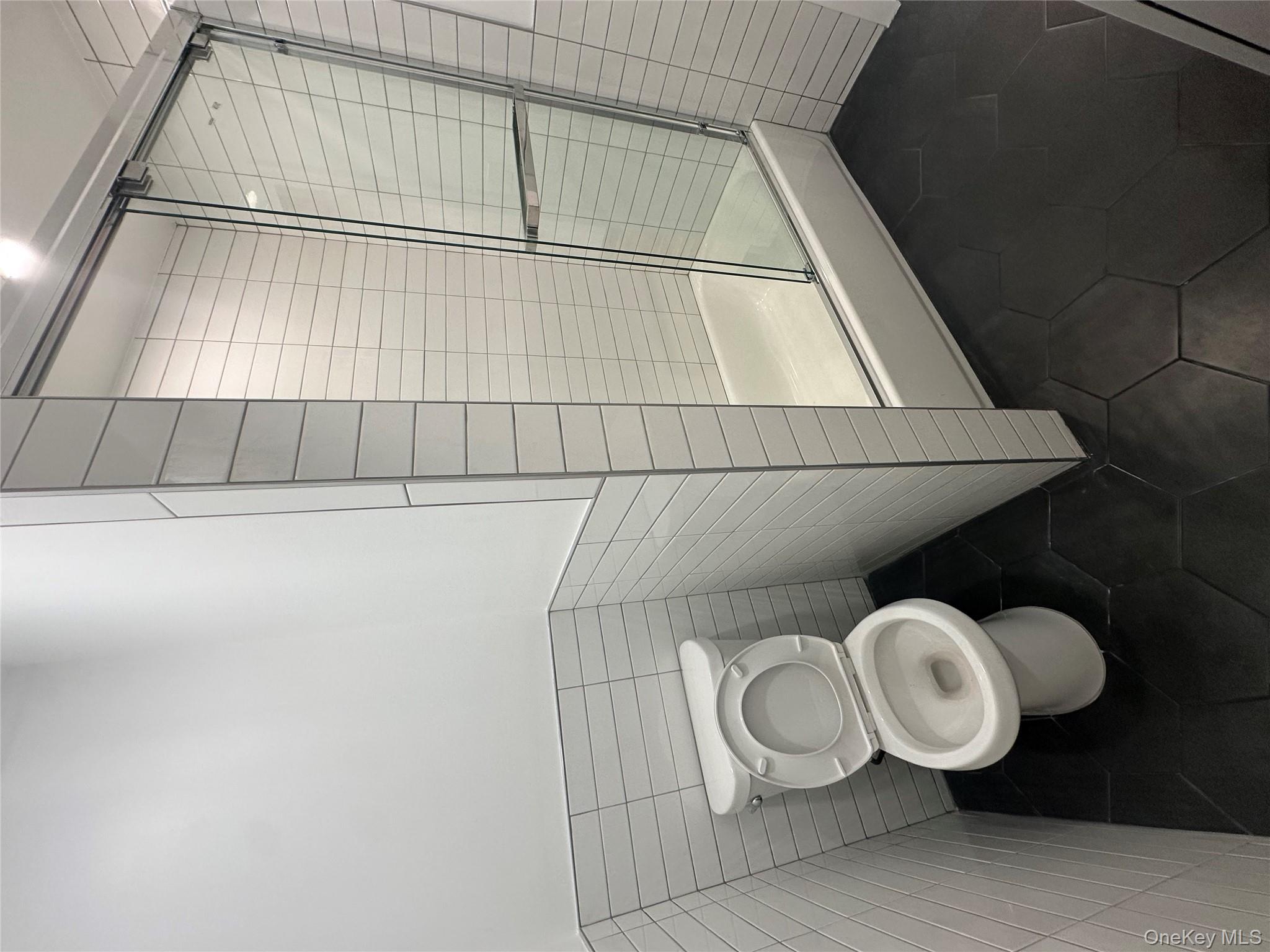 Undisclosed Address Queens, NY 11416 - Photo 10 of 10 a bathroom with a toilet and a shower