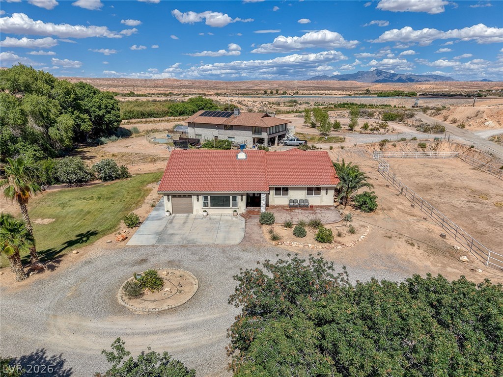 1950 Bowman Road Logandale, NV 89021 - Photo 63 of 81 A terracotta-tiled roof crowns this residence, featuring a circular driveway and verdant surroundings.