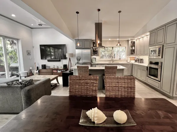 a kitchen with stainless steel appliances kitchen island granite countertop a stove and a wooden floor