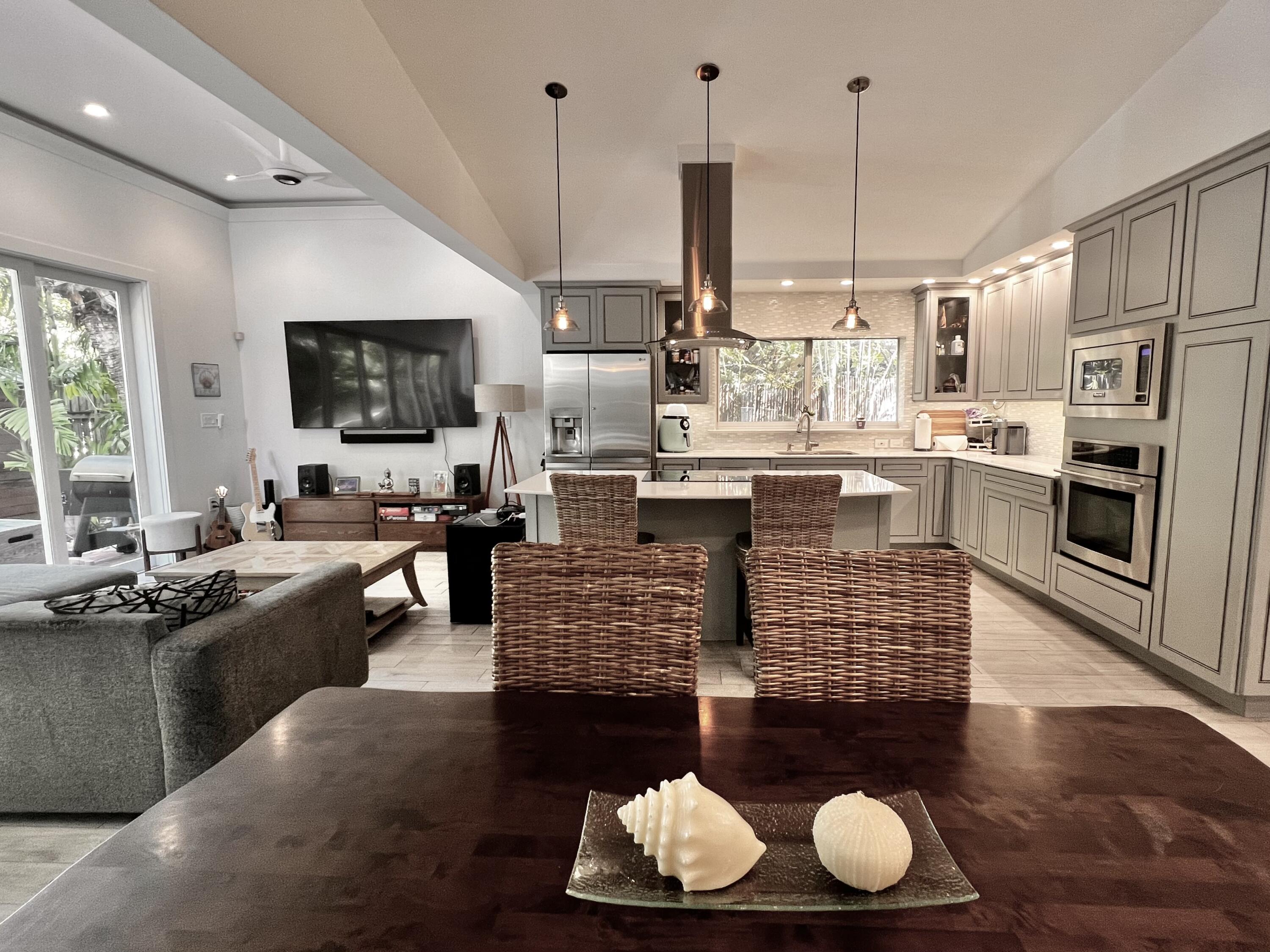 a kitchen with stainless steel appliances kitchen island granite countertop a stove and a wooden floor