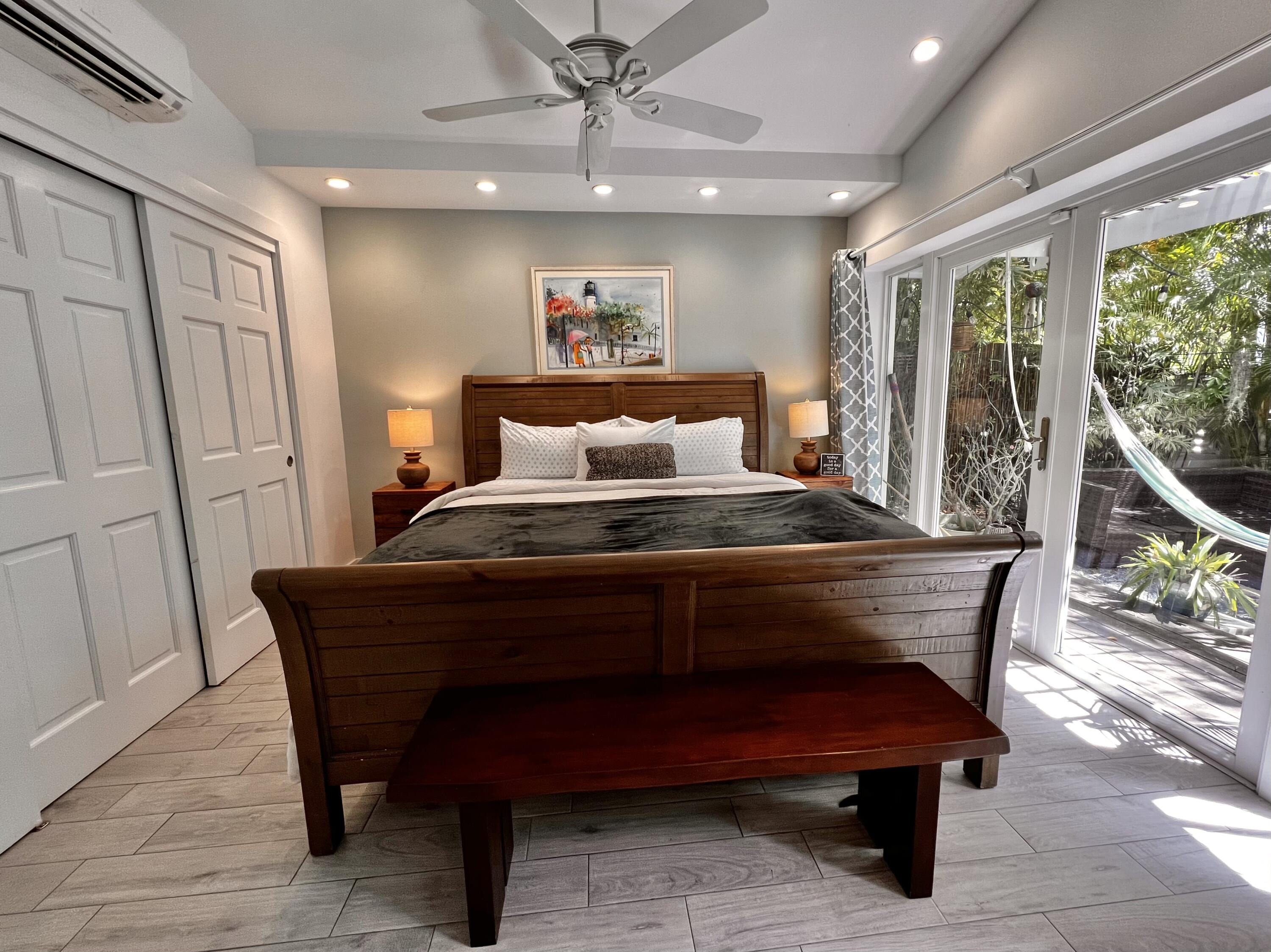 1421 Reynolds Street Key West, FL 33040 - Photo 13 of 45 a living room with furniture a large window and a chandelier