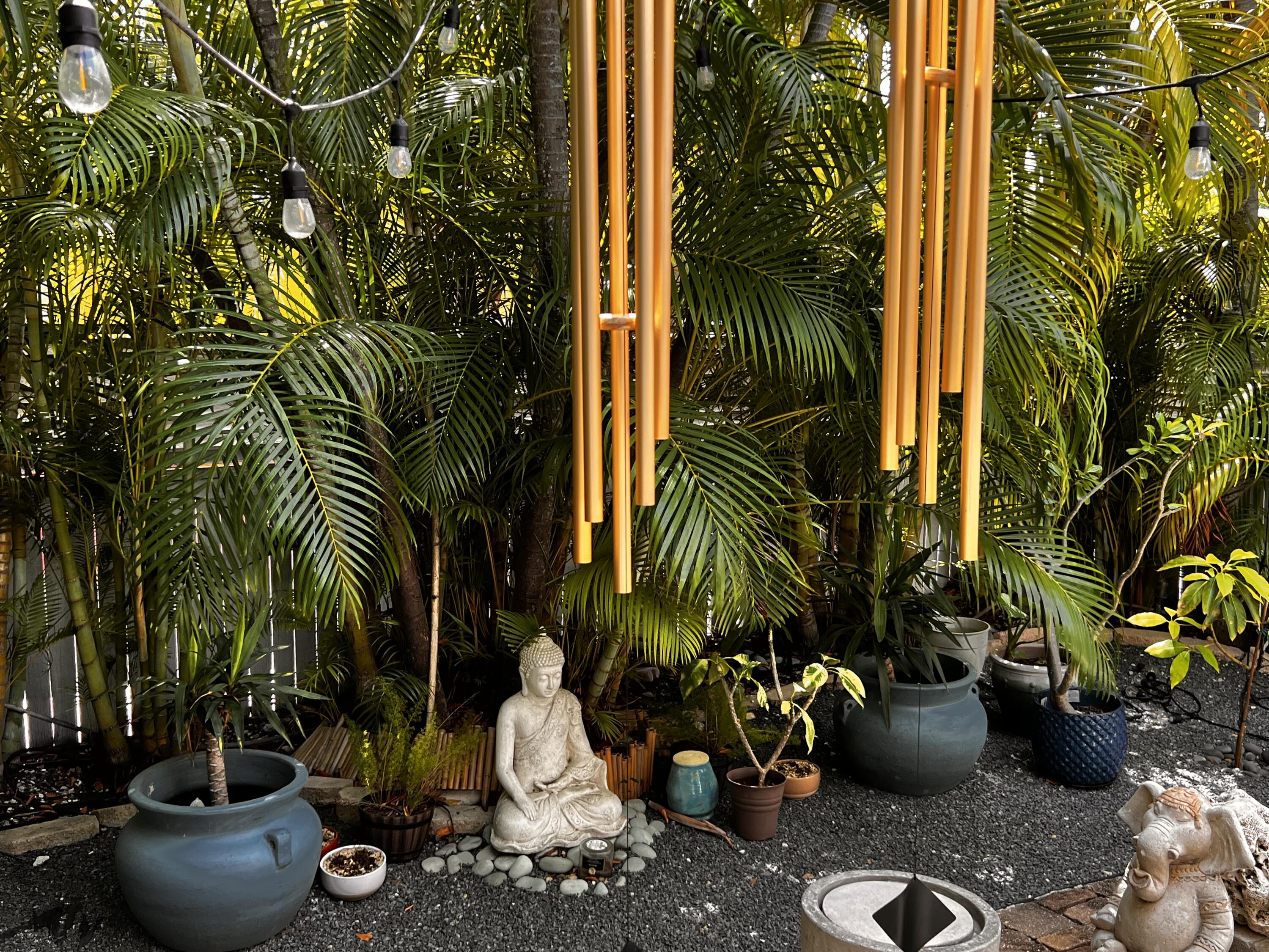 1421 Reynolds Street Key West, FL 33040 - Photo 18 of 45 a view of a backyard with potted plants and water fountain