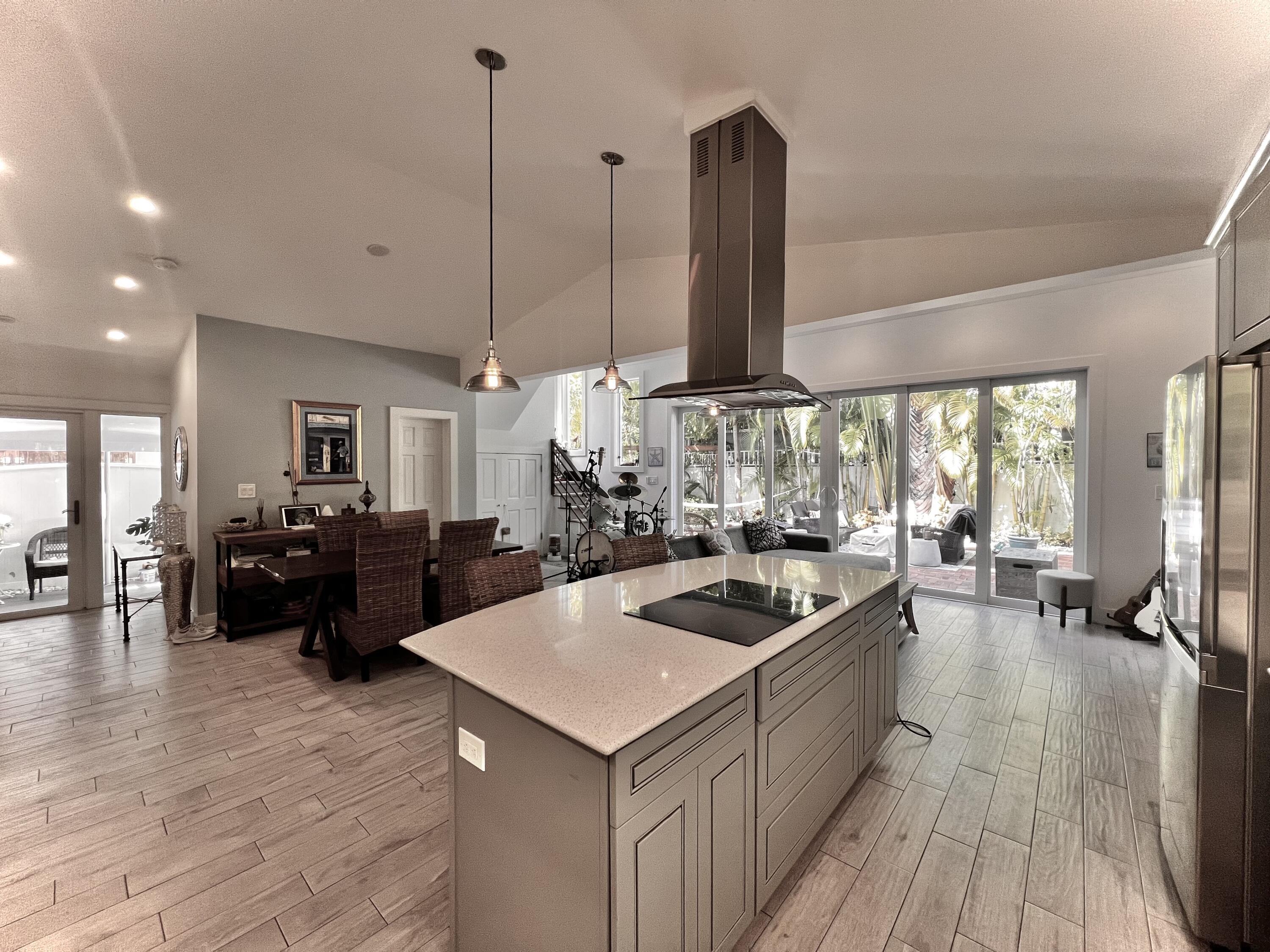 1421 Reynolds Street Key West, FL 33040 - Photo 2 of 45 a kitchen with a stove and a wooden floor