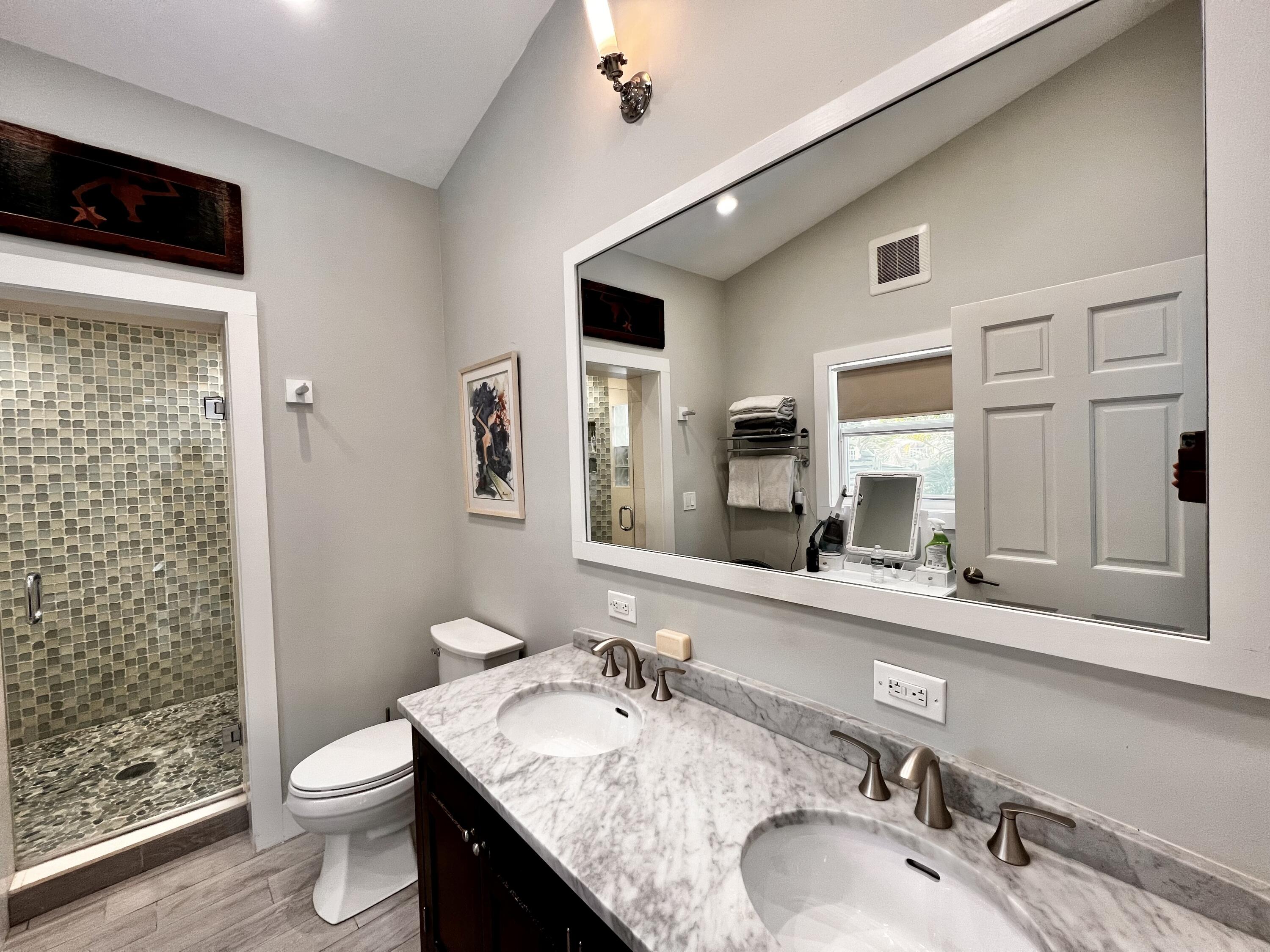 1421 Reynolds Street Key West, FL 33040 - Photo 21 of 45 a bathroom with a granite countertop sink toilet and shower