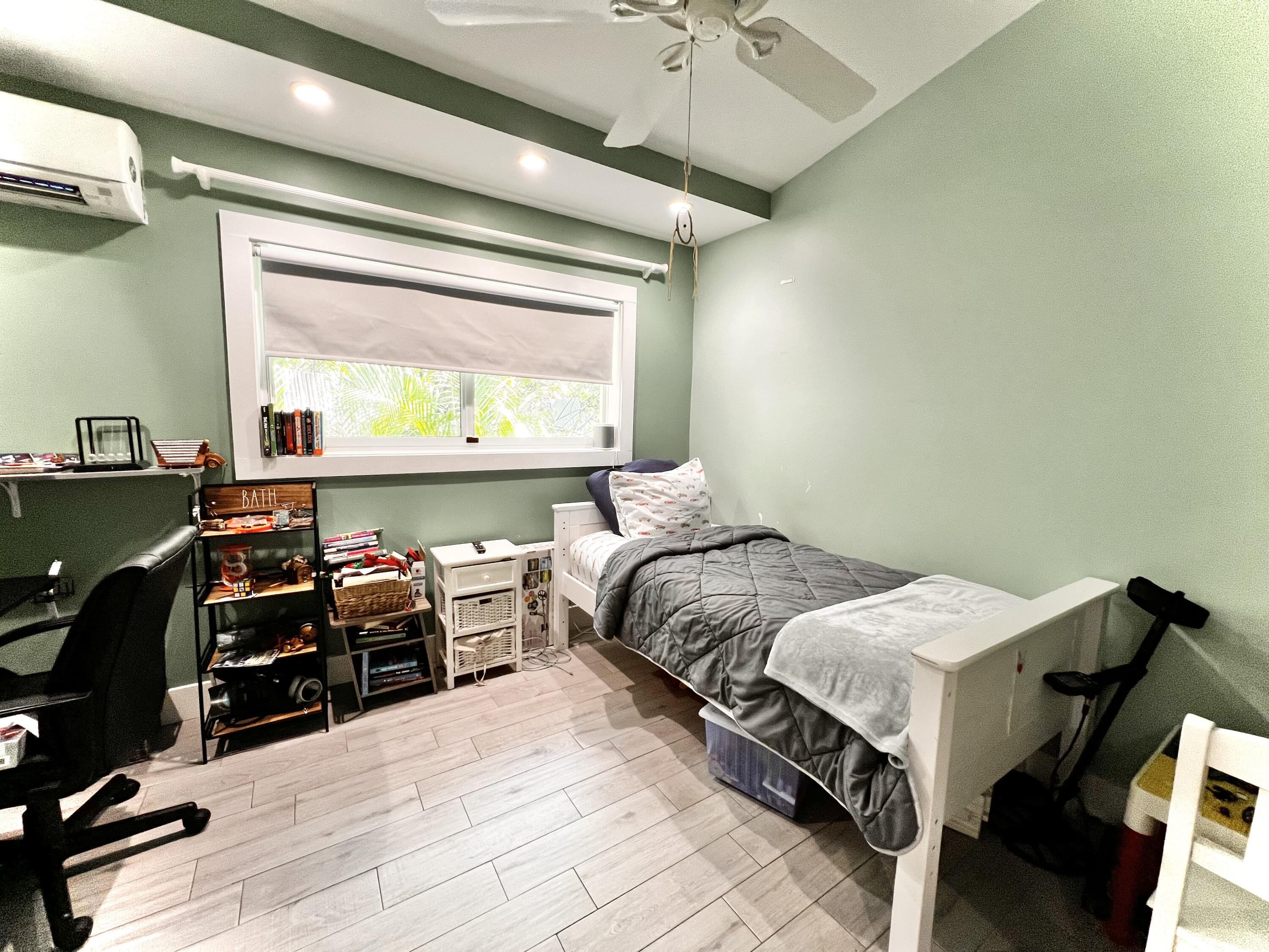 1421 Reynolds Street Key West, FL 33040 - Photo 27 of 45 a bedroom with a bed and a dresser