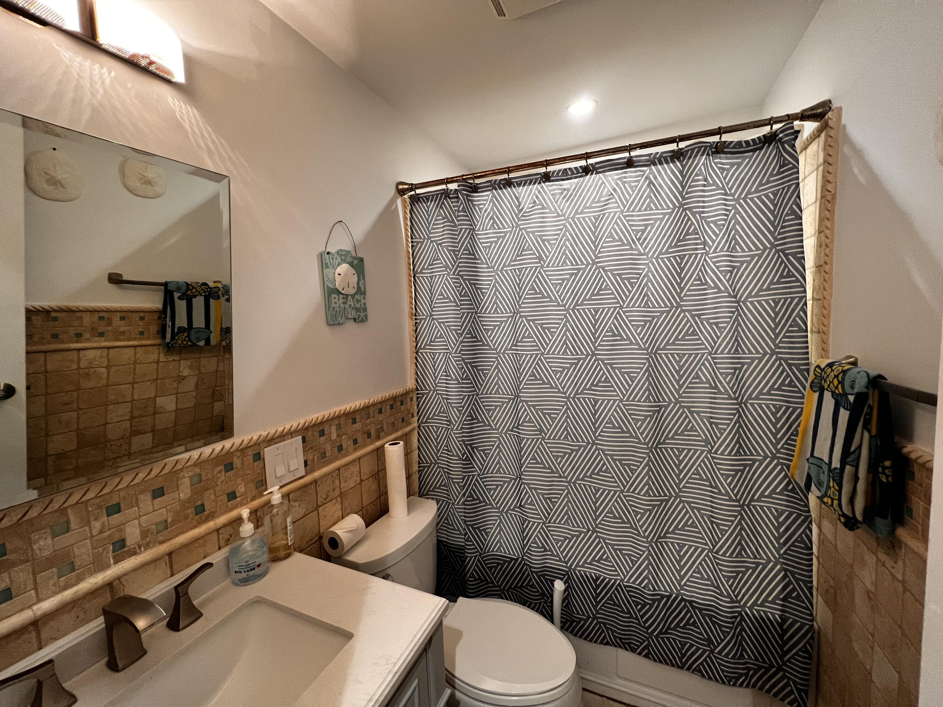 1421 Reynolds Street Key West, FL 33040 - Photo 29 of 45 a bathroom with a sink a toilet a mirror and shower