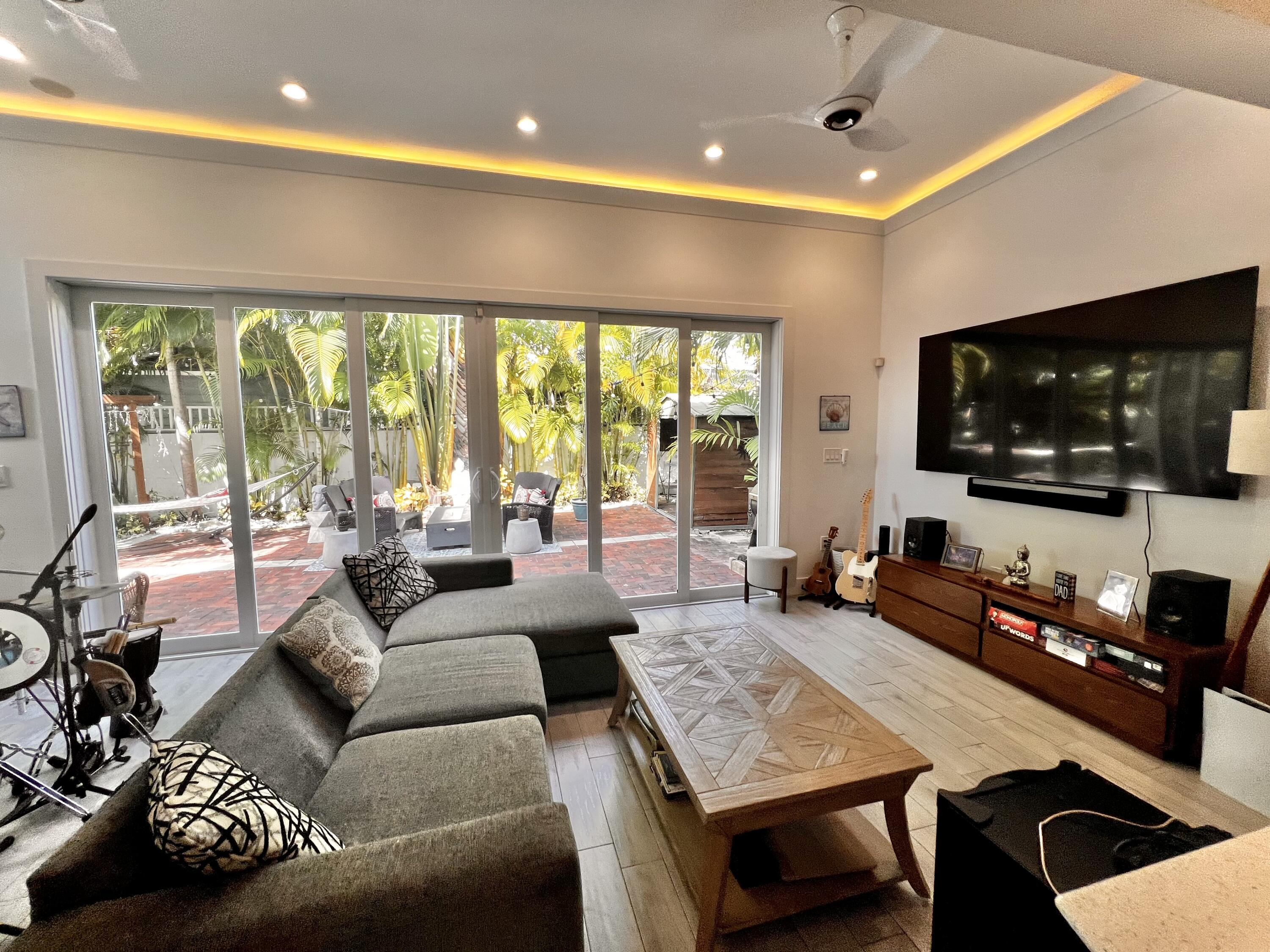 1421 Reynolds Street Key West, FL 33040 - Photo 4 of 45 a living room with furniture and a flat screen tv