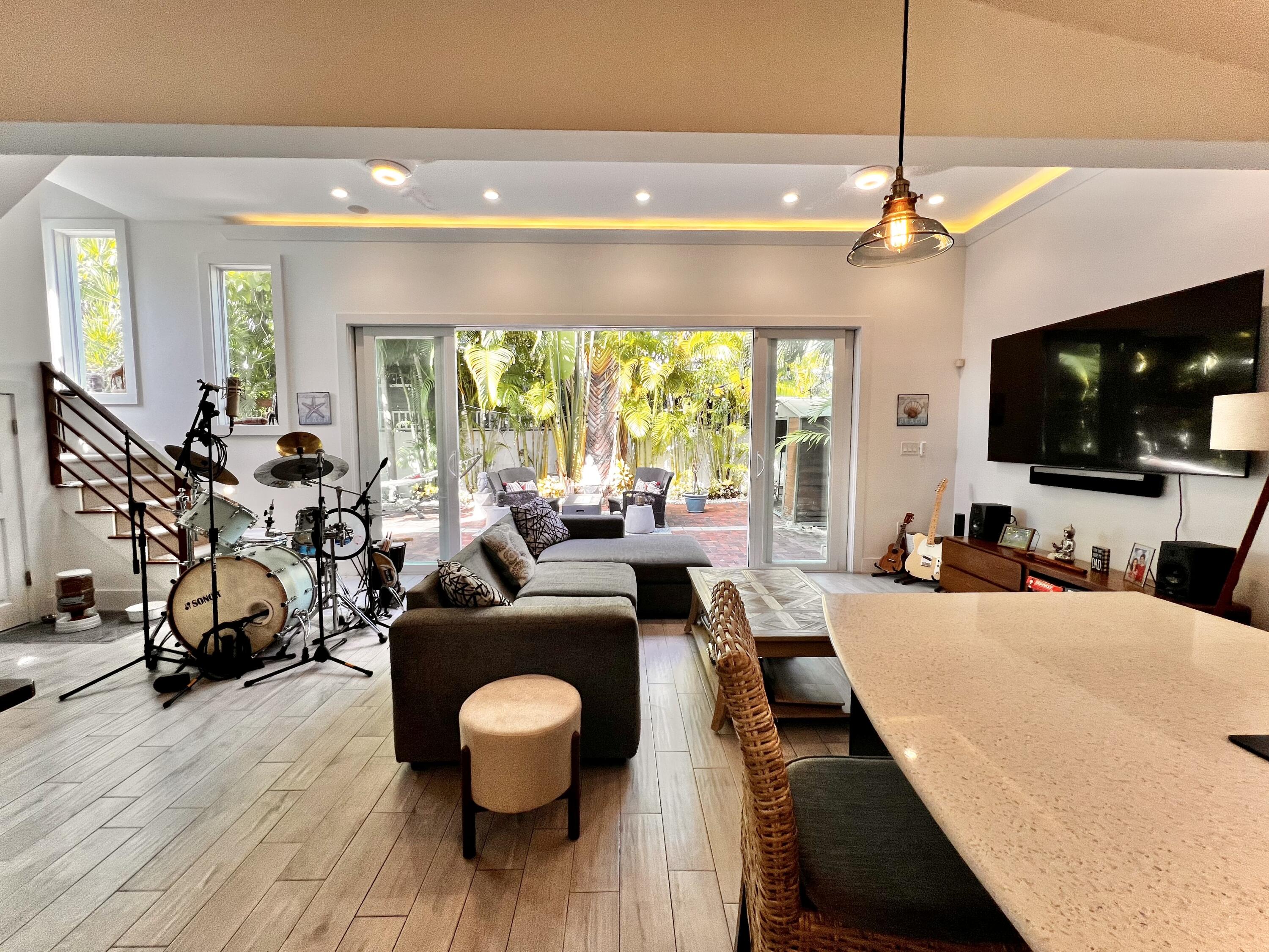 1421 Reynolds Street Key West, FL 33040 - Photo 6 of 45 a living room with furniture a flat screen tv and a large window