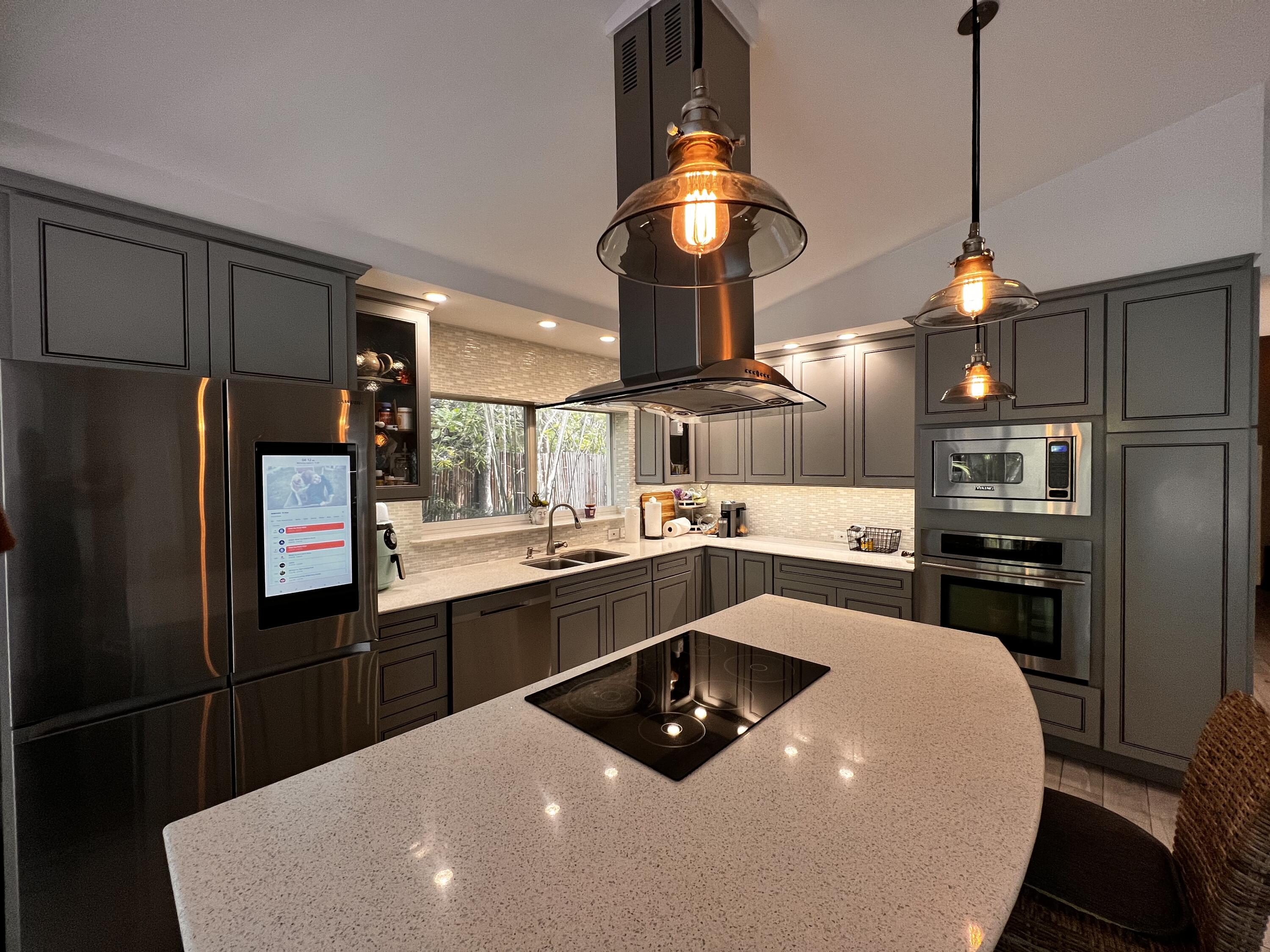 1421 Reynolds Street Key West, FL 33040 - Photo 8 of 45 a kitchen with stainless steel appliances a sink a stove a refrigerator and chairs