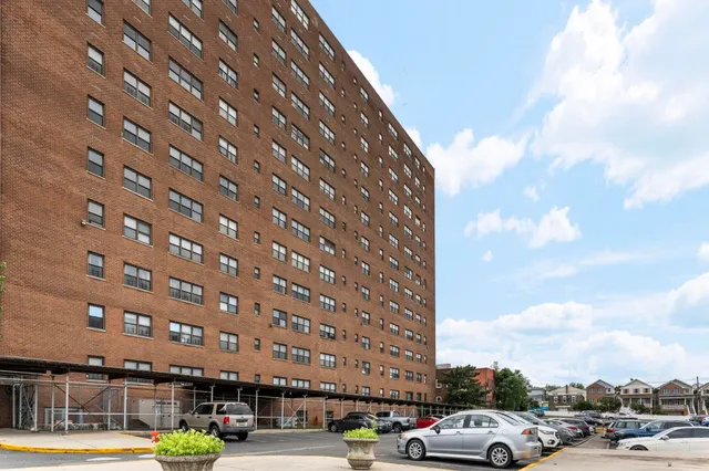 a view of building with cars parked