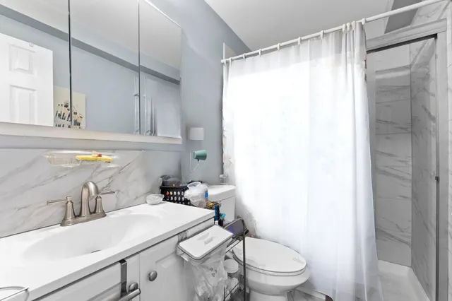 a bathroom with a sink toilet and shower