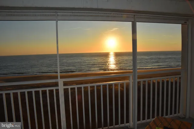 a view of a balcony next to a yard