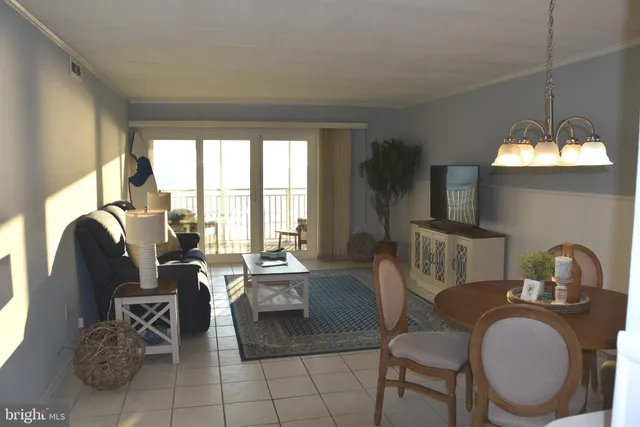 a living room with furniture a window and a flat screen tv