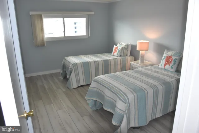 a bedroom with two beds and a window