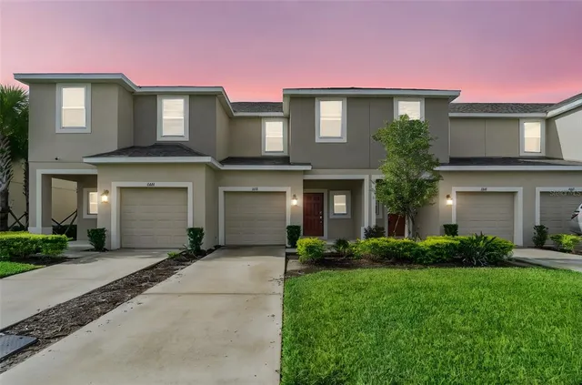 a front view of a house with a yard and garage