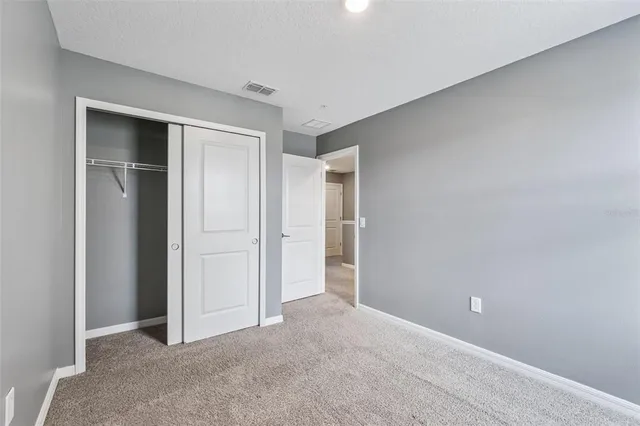 a view of an empty room and closet area