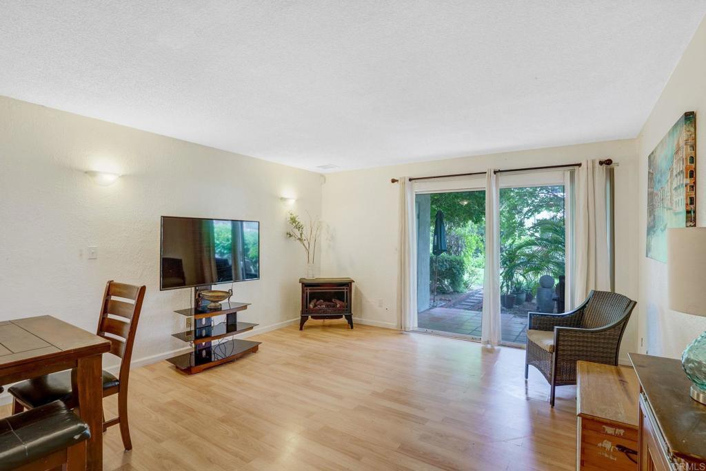 150 E Street, Unit A1 Chula Vista, CA 91910 - Photo 14 of 55 a living room with furniture a fireplace and a flat screen tv