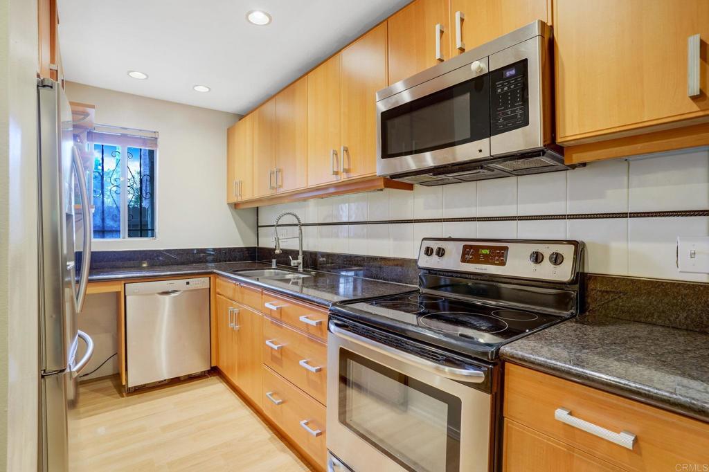 150 E Street, Unit A1 Chula Vista, CA 91910 - Photo 6 of 55 a kitchen with a stove and a microwave